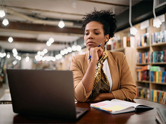 Serious woman using laptop