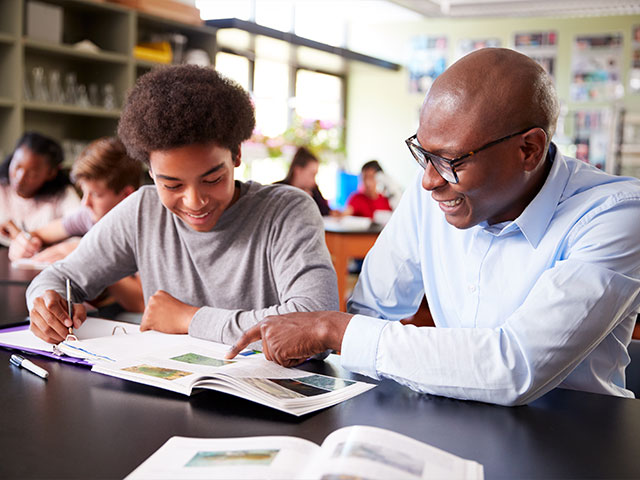 Teacher helping student in Health class