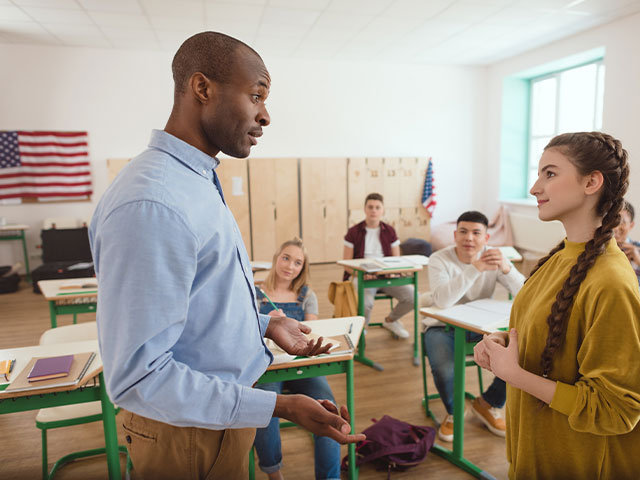 Teacher and student discussing political science assignment